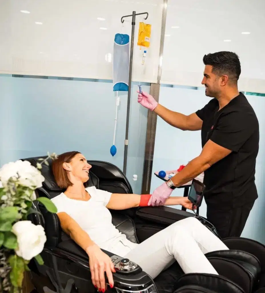 Casa Privée nutritional counselor with patient during vitamin IV therapy in Miami. IV therapy for energy, immunity, and anti-aging.